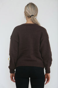 Cardigan – Cozy knit, playful floral details.